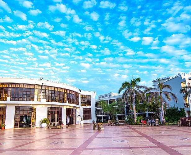 Modern conference center exterior with palm trees